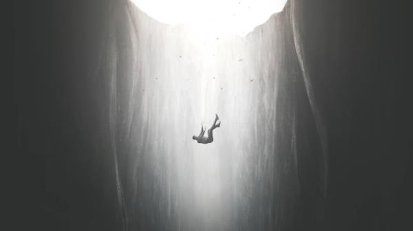 Person falling into abyss