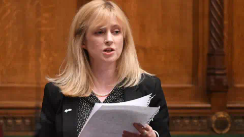 Reuters Member of Parliament (MP) Rosie Duffield delivers a speech during a session at Westminster. She is holding a sheet of paper.